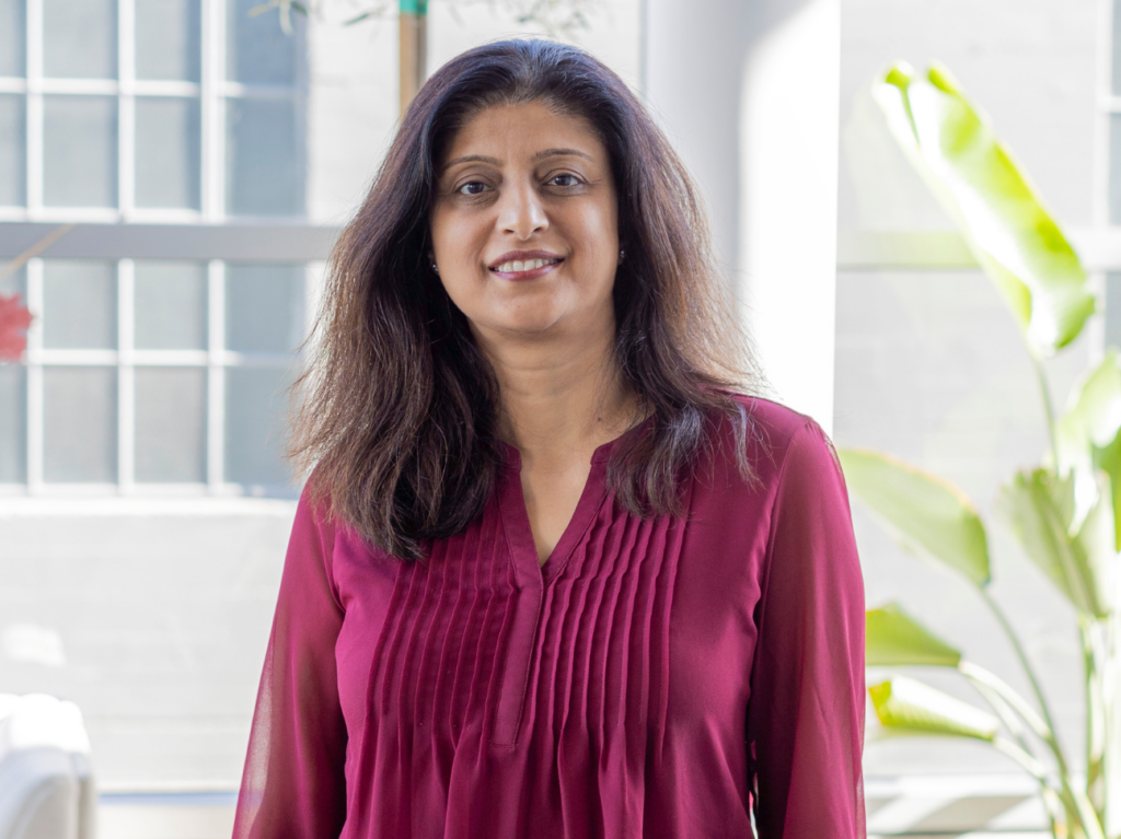 Shibani Sanan the new chief technology officer at Ladder stands in the Ladder office wearing a red shirt